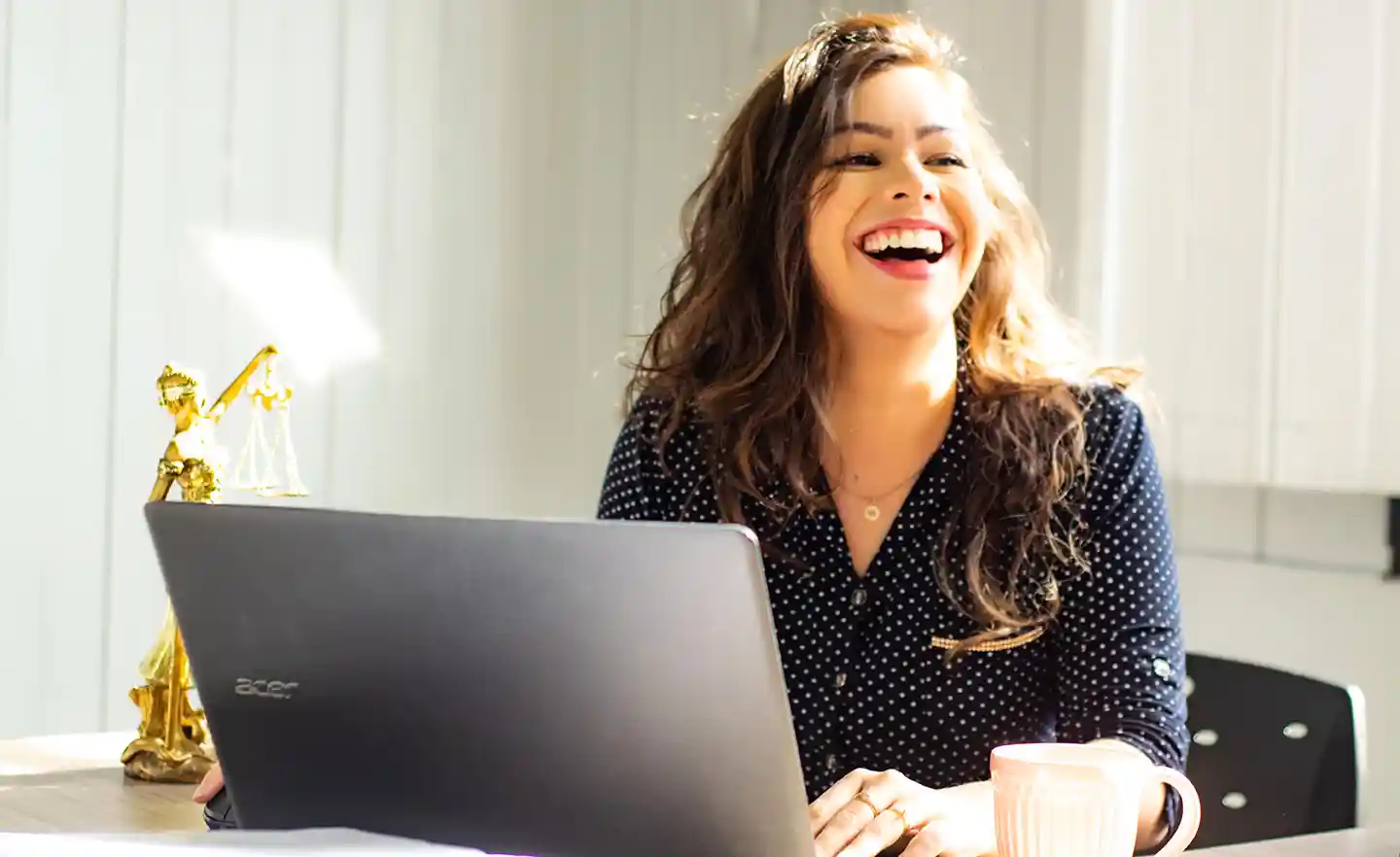 woman smiling at computer